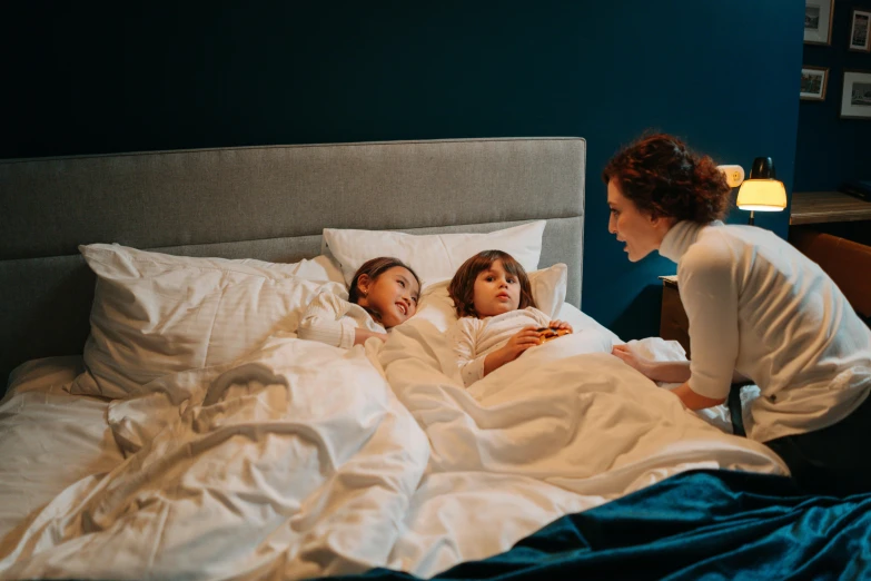 a woman and two children laying in a bed, by Adam Marczyński, pexels contest winner, calmly conversing 8k, profile image, bed on the right, ad image