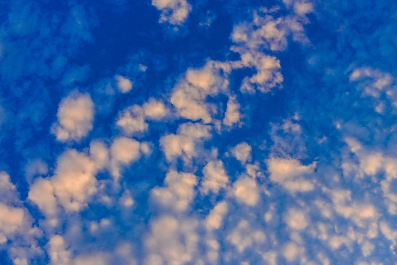 a plane flying through a cloudy blue sky, an album cover, by Jan Rustem, unsplash, surrealism, layered stratocumulus clouds, beautiful late afternoon, psychedelic clouds, high definition photo