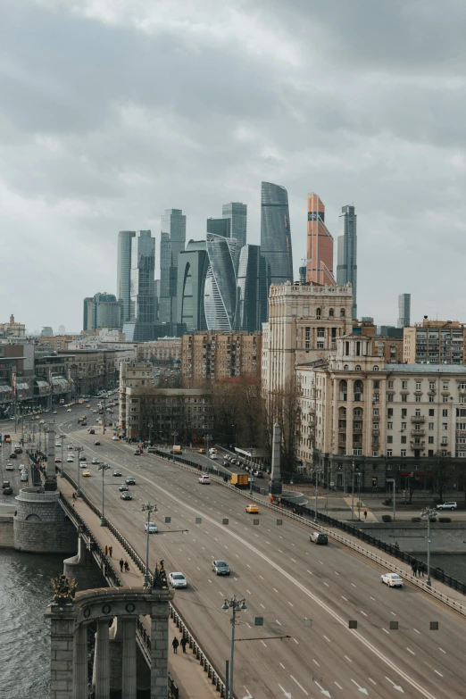 a city filled with lots of tall buildings next to a river, by Fyodor Rokotov, pexels contest winner, socialist realism, russian architecture, zaha hadid style architecture, slight overcast weather, 000 — википедия