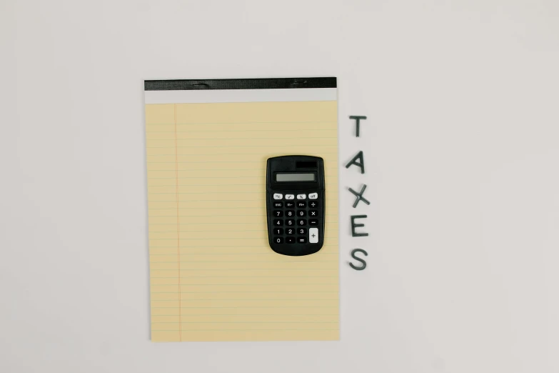 a calculator sitting on top of a piece of paper, an album cover, by Andries Stock, pexels, conceptual art, taxi, minimalist logo without text, writing on a clipboard, staples