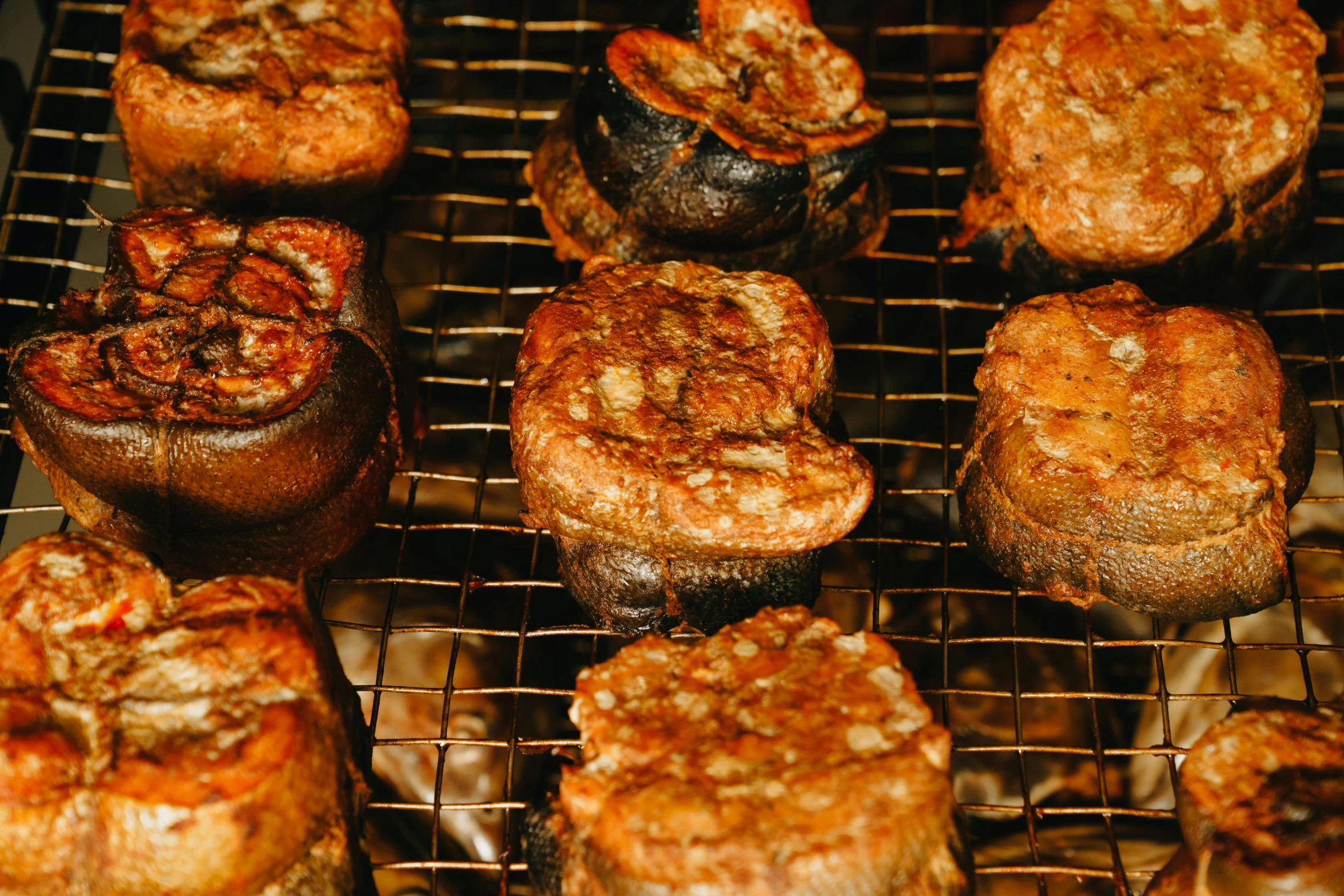 a bunch of mushrooms that are cooking on a grill, unsplash, mingei, salmon khoshroo, thumbnail, battered, woodfired