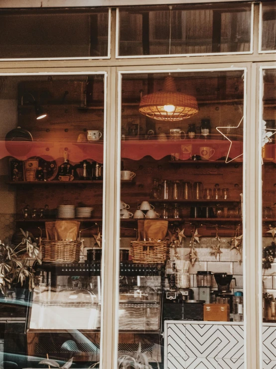 a store window that has a bunch of items in it, by Niko Henrichon, trending on unsplash, cafe interior, brown, low quality photo, front lit