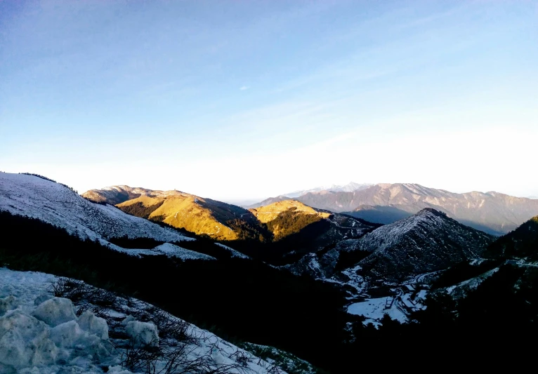 a man riding a snowboard on top of a snow covered slope, by Alexis Grimou, unsplash contest winner, les nabis, sunset panorama, photo taken with an iphone, hiking in rocky mountain, arrendajo in avila pinewood