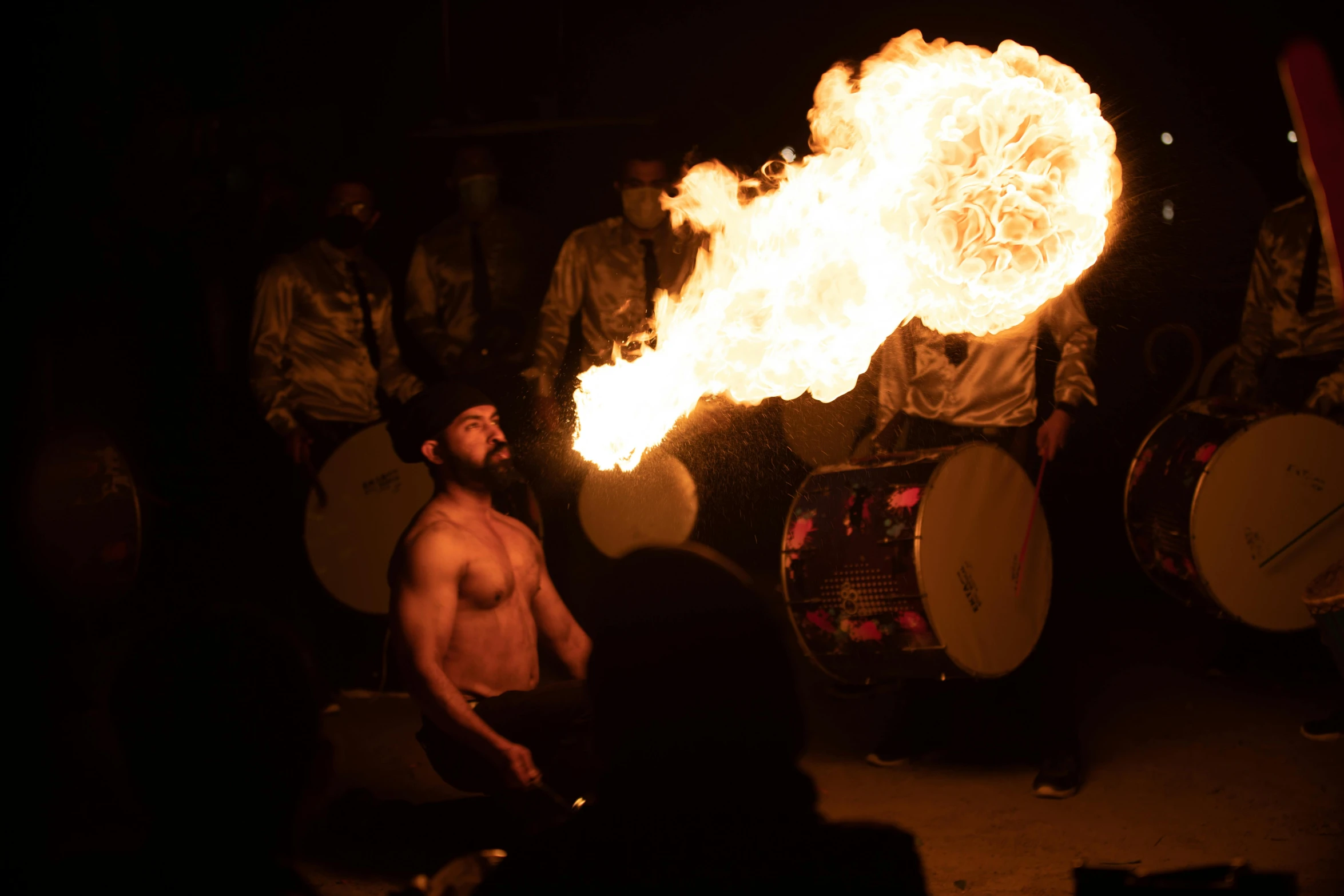 a man that is standing in front of a fire, pexels contest winner, kinetic art, “house music rave with dancers, kitsune holding torch, manly, circus performance