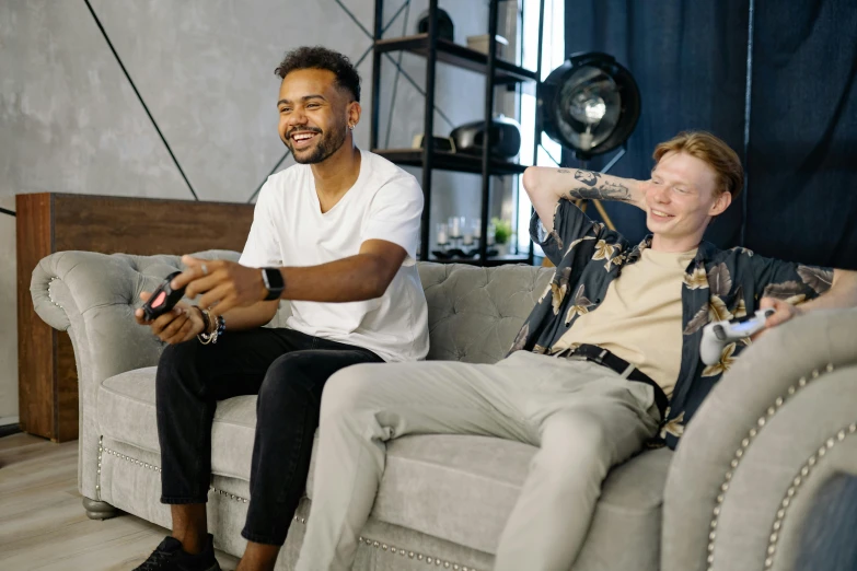 two men sitting on a couch playing a video game, pexels contest winner, bowater charlie and brom gerald, taking control while smiling, promo image, gray men