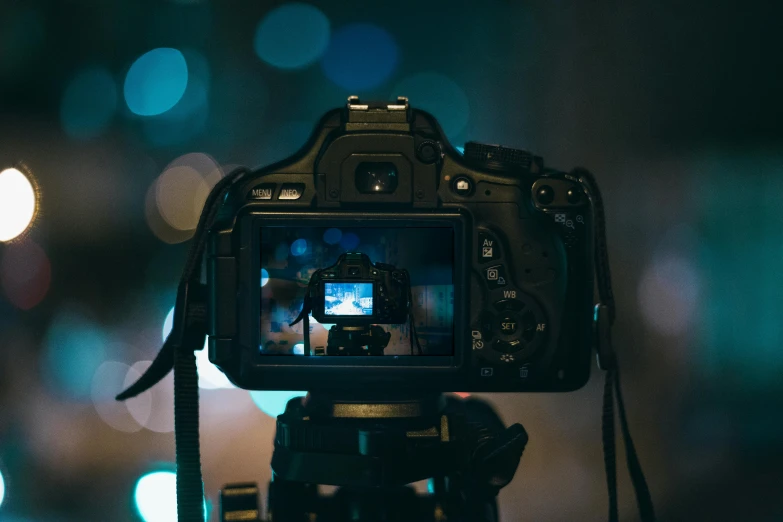 a camera that is sitting on a tripod, a picture, unsplash contest winner, rayonism light effects and bokeh, night time footage, 4k dslr, turned back to camera