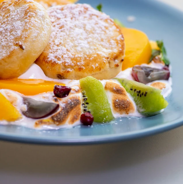 a close up of a plate of food on a table, manuka, pancakes, multi colour, passion fruits