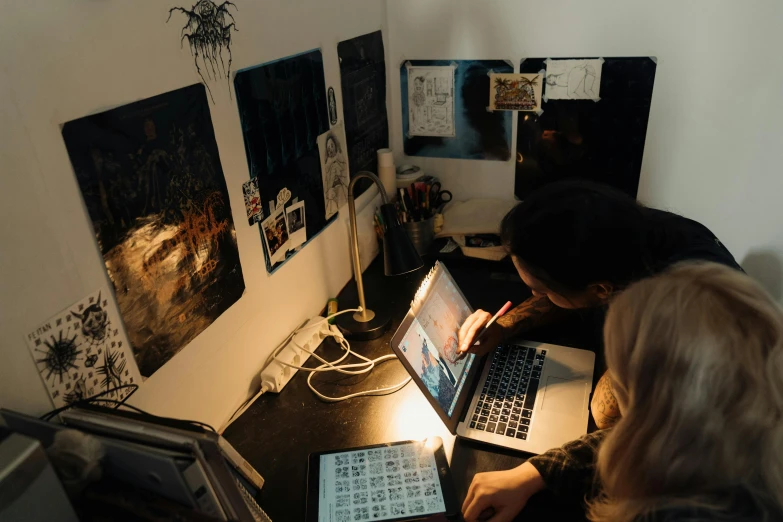 a couple of people sitting at a desk with laptops, trending on pexels, analytical art, female emo art student, thumbnail, lighting, low quality photo