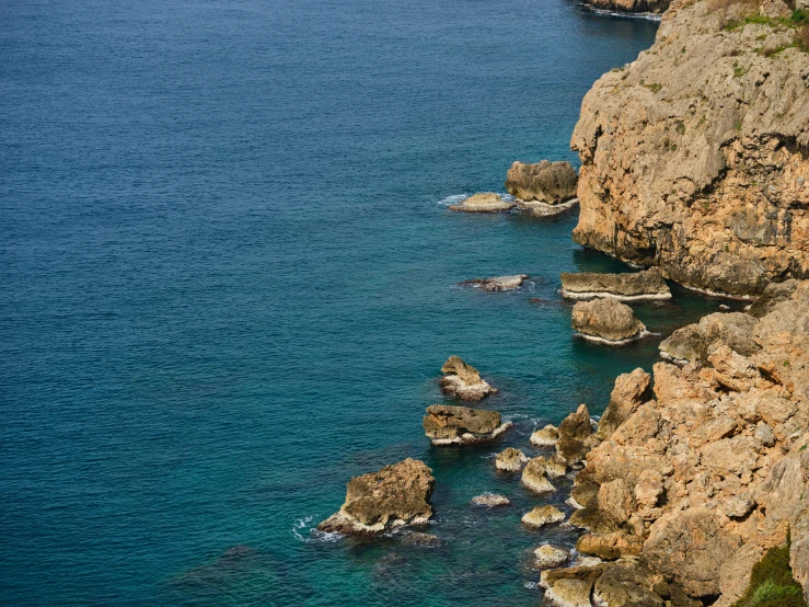 a couple of boats sitting on top of a body of water, les nabis, coastal cliffs, costa blanca, top - down photograph, deep colours. ”