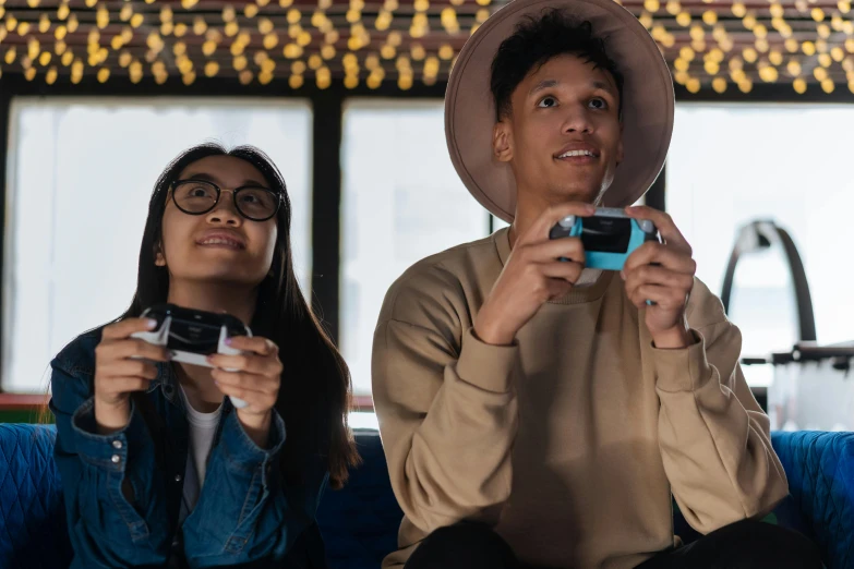 two people sitting on a couch playing video games, pexels contest winner, avatar image, teenager hangout spot, futuristic nft card game, portrait photo