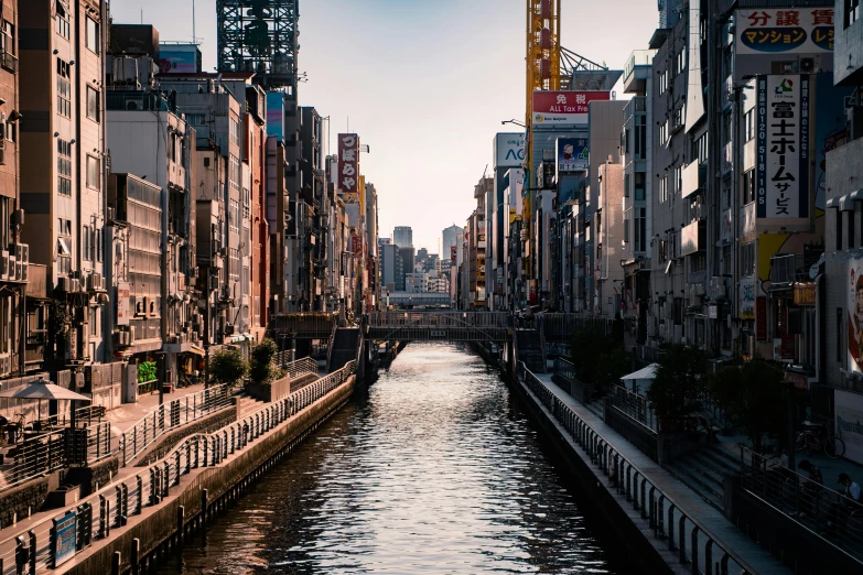 a river running through a city next to tall buildings, inspired by Kōshirō Onchi, unsplash contest winner, canals, sasoura, 2 0 2 2 photo, festivals