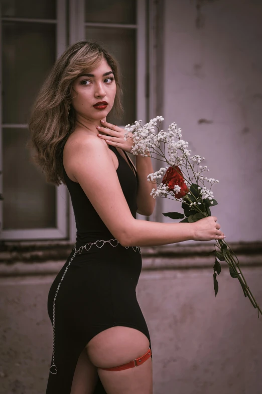 a woman in a black dress holding a bunch of flowers, a colorized photo, inspired by Elsa Bleda, pexels contest winner, realism, :: madison beer, red rose, tight dress, side portrait of imogen poots