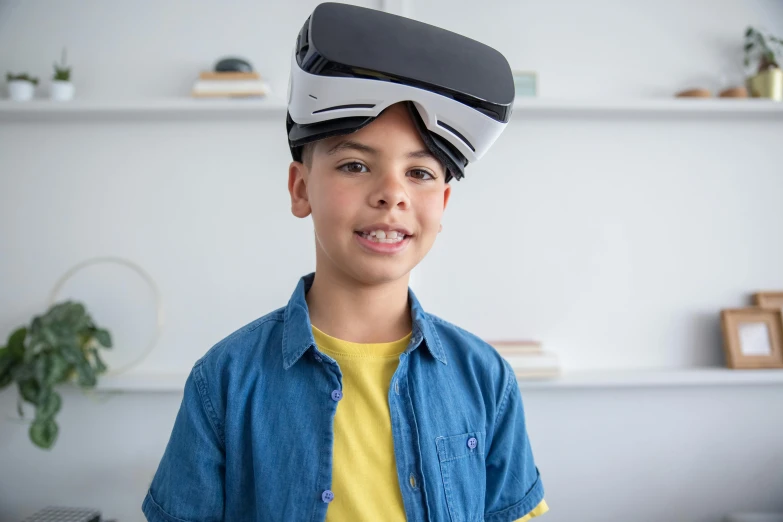 a young boy wearing a virtual reality headset, inspired by Jean Tabaud, 3/4 front view, while smiling for a photograph, upgrade to max, showing forehead