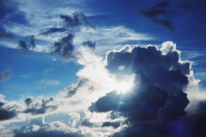 the sun is shining through the clouds in the sky, unsplash, shades of blue, dramatic ”, dramatic”