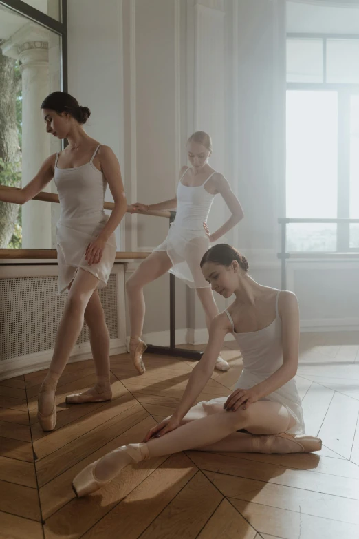 a group of ballerinas sitting on the floor in front of a mirror, by Elizabeth Durack, trending on unsplash, arabesque, delicate soft hazy lighting, on a white table, trio, promo image