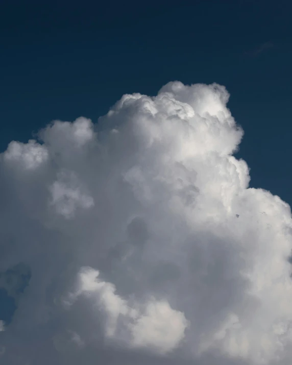 a jetliner flying through a cloudy blue sky, unsplash, giant cumulonimbus cloud, ☁🌪🌙👩🏾, very fluffy, looking upwards