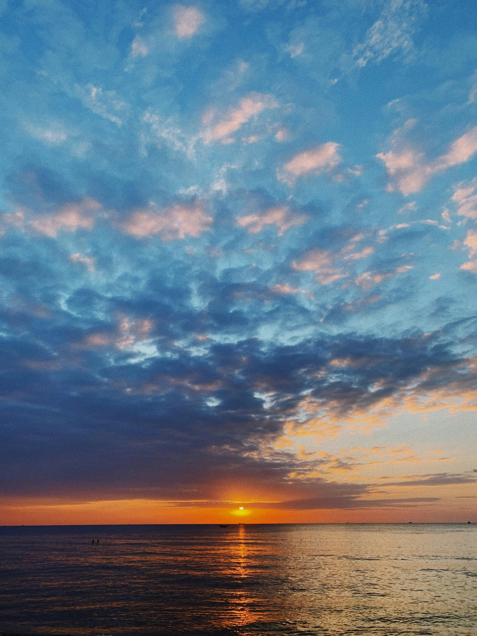 a large body of water with a sunset in the background, skies, panoramic