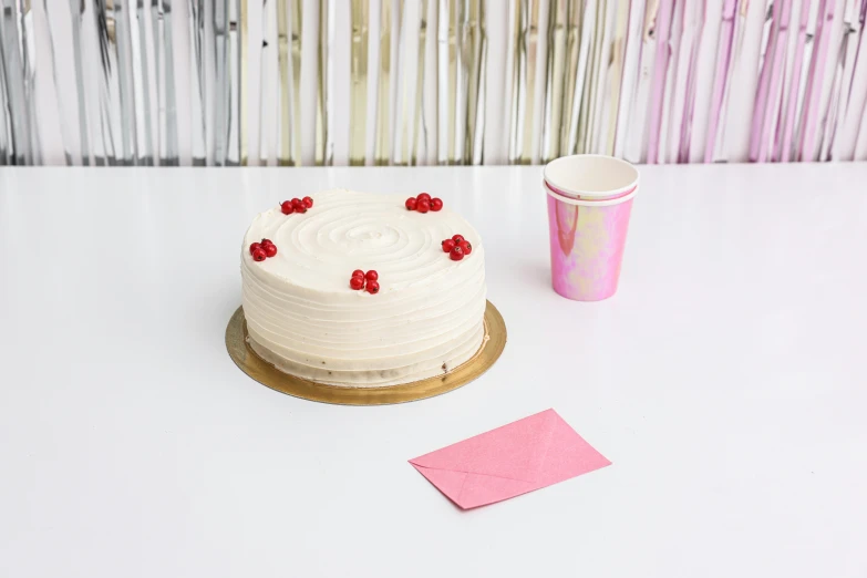 a white cake sitting on top of a white table, by Arabella Rankin, paper cup, pink and red color scheme, textured base ; product photos, a wooden