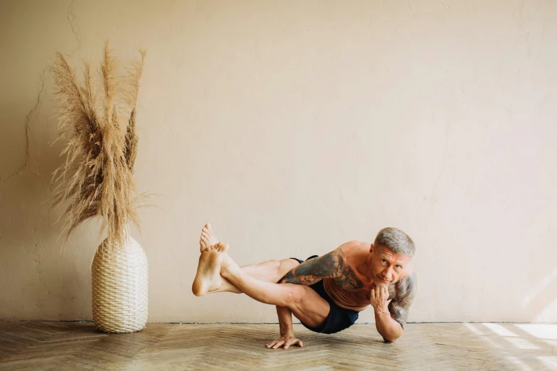 a man doing a yoga pose in front of a vase, unsplash, 🦩🪐🐞👩🏻🦳, portrait image, wrinkles and muscles, avatar image