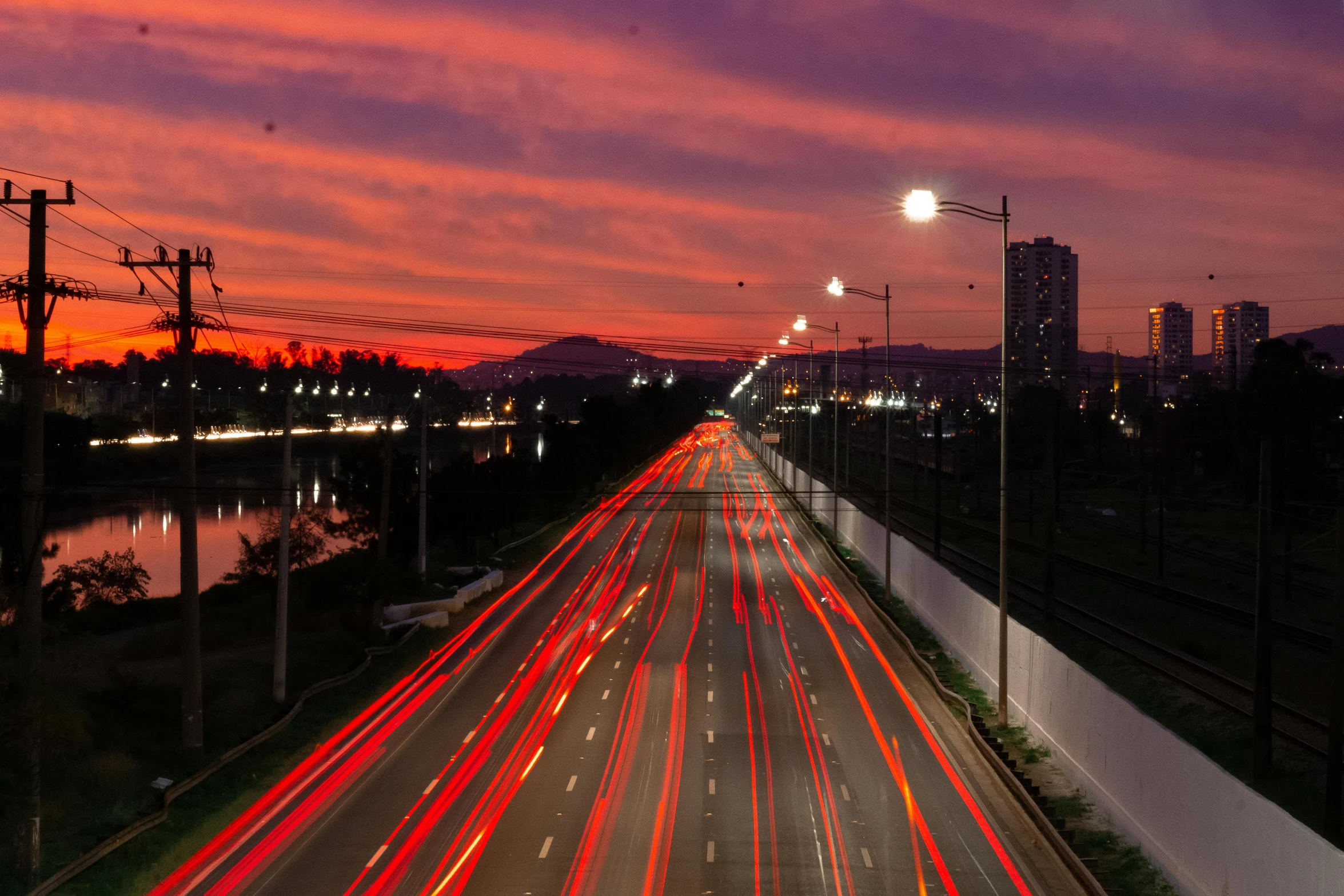 a city street filled with lots of traffic at night, an album cover, by Alejandro Obregón, pexels contest winner, highway and sunset!!, oscar niemeyer, youtube thumbnail, multiple stories