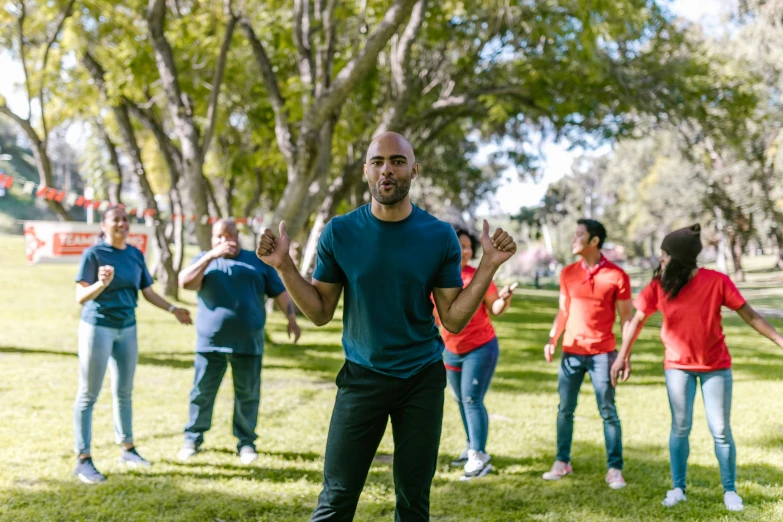 a group of people playing frisbee in a park, an album cover, inspired by Liao Chi-chun, pexels contest winner, figuration libre, a bald, stands in center with open arms, sydney, meet the actor behind the scenes