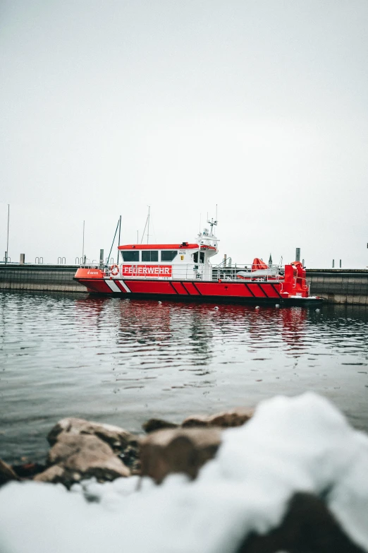 a red boat sitting on top of a body of water, red and white, vehicle, siren, full body image