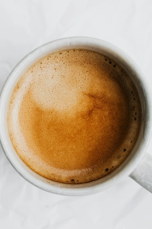 a close up of a cup of coffee, zoomed out, recipe, detailed product image, brown mist