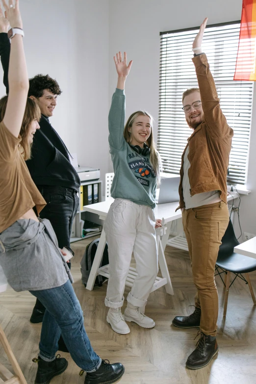 a group of people that are standing in a room, playful pose, highly upvoted, in an office, wearing casual clothes