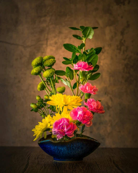 a vase filled with colorful flowers on top of a wooden table, a still life, inspired by Itō Jakuchū, unsplash, high resolution photo, green and yellow, vibrant backlit, fragrant plants