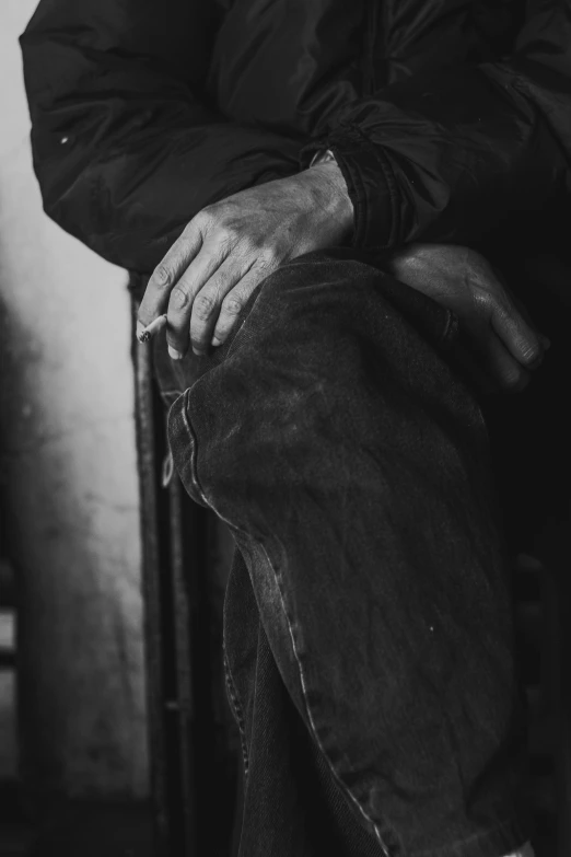 a black and white photo of a man sitting on a chair, inspired by Germaine Krull, pexels contest winner, photorealism, worn pants, closeup of arms, blacksmith, 15081959 21121991 01012000 4k