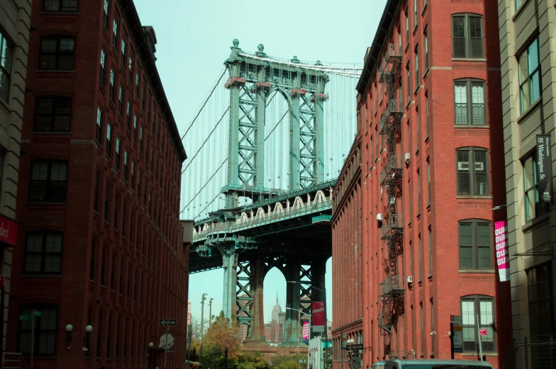 a view of a bridge over a city street, a colorized photo, inspired by Thomas Struth, pexels contest winner, hyperrealism, red building, brooklyn, brown, medium format color photography