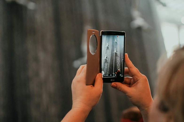 a woman taking a picture with her cell phone, a picture, pexels contest winner, cardboard pinhole camera, with a sleek spoiler, picture through the screen, tall angle