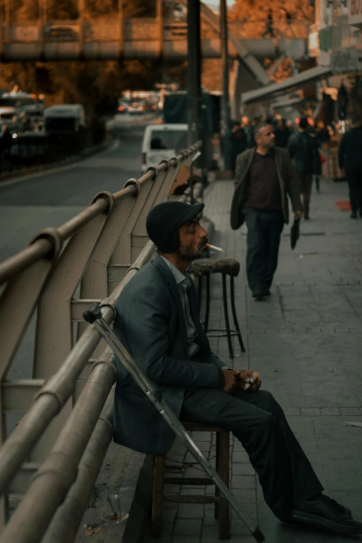 a man sitting on a bench on a city street, pexels contest winner, featured in cinematic, black man, grayish, background bar