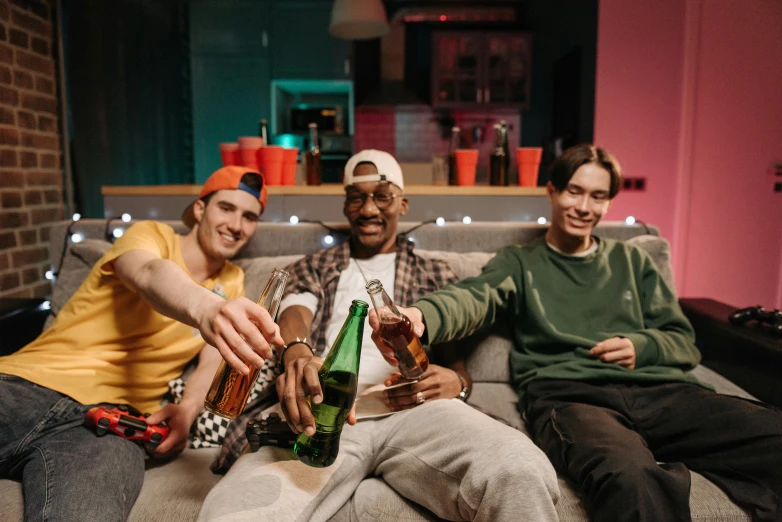 a group of men sitting on top of a couch, pexels, bottle, photograph of three ravers, roomies, avatar image