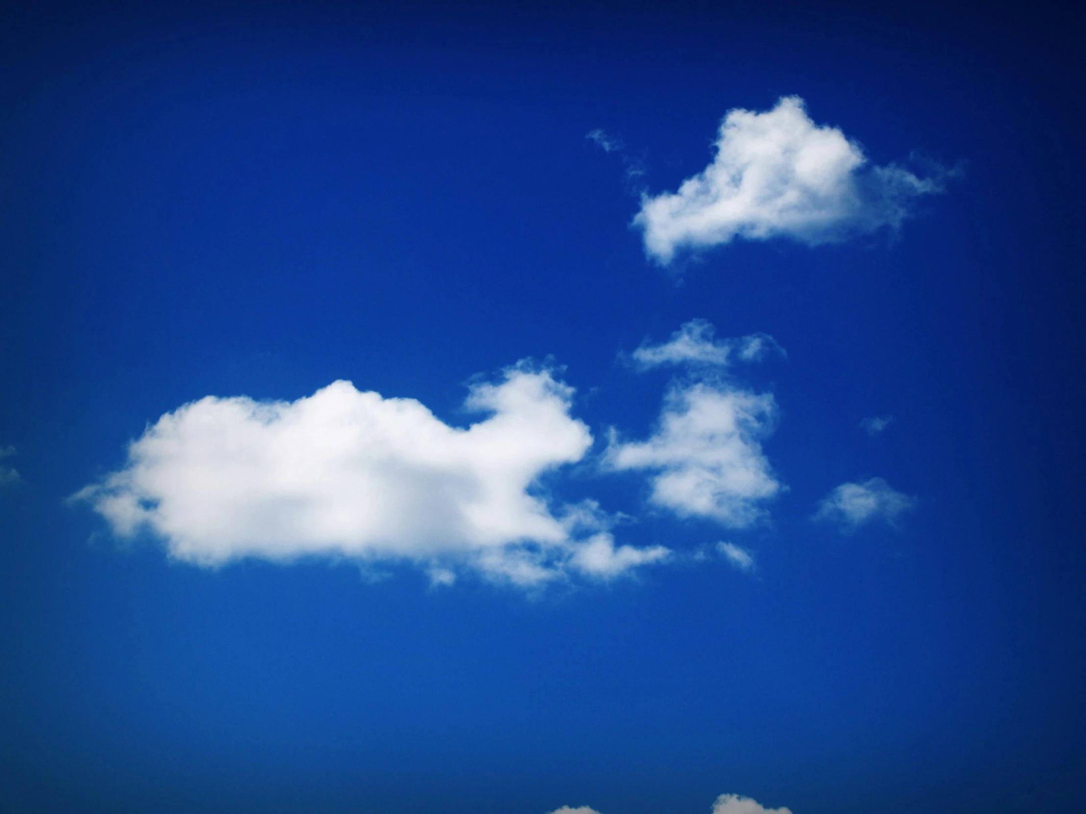 a couple of clouds that are in the sky, by Alison Geissler, minimalism, blue, journalism photo, rectangle, vibrant blue