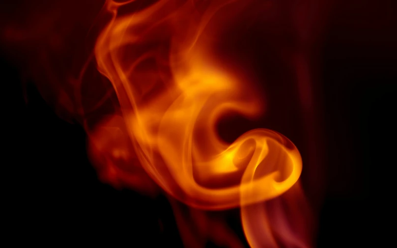 a close up of a fire on a black background, pexels, with red haze, swoosh, instagram post, profile image