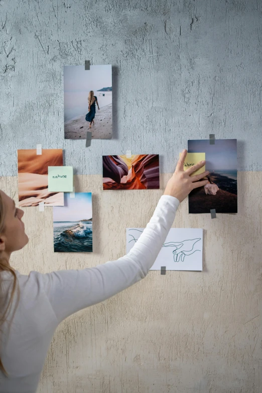 a woman is hanging pictures on a wall, trending on pexels, 3d collage, detailed product image, subject in the centre, sticky