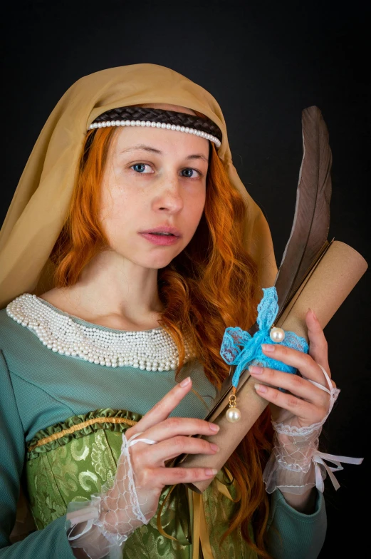 a woman dressed in medieval clothing holding a feather, a portrait, inspired by Master of the Legend of Saint Lucy, flickr, cosplay photo, scrolls, hr ginger, sqare-jawed in medieval clothing