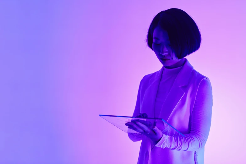 a woman holding a tablet in front of a purple background, inspired by Gao Cen, pexels contest winner, full body backlight, muted neon colors, still from the movie ex machina, asian women