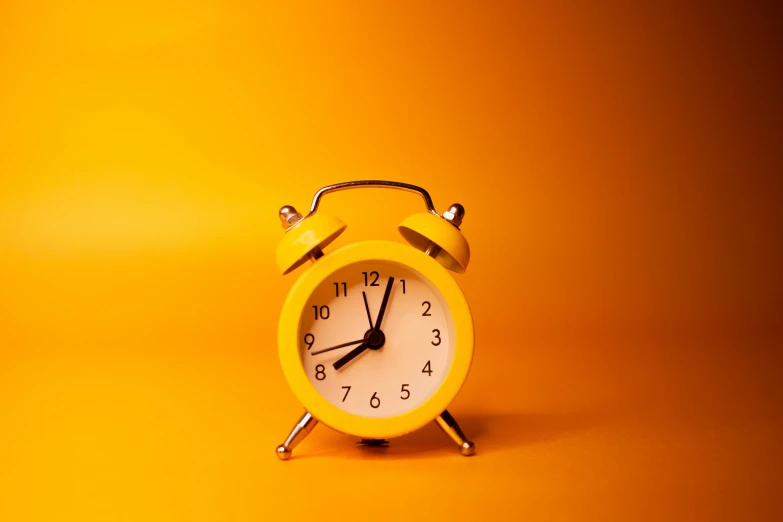 a yellow alarm clock on a yellow background, trending on pexels, profile pic, orange hue, ancient times, aaaaaaaaaaaaaaaaaaaaaa