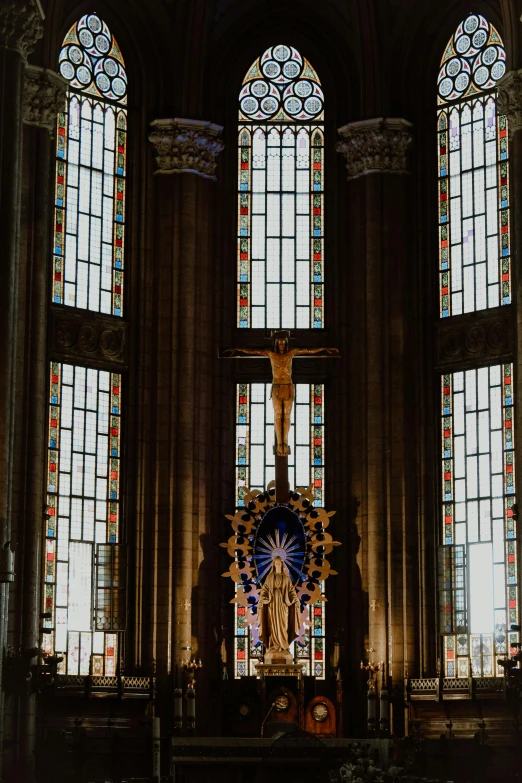 the interior of a church with stained glass windows, a statue, by Barthélemy d'Eyck, unsplash contest winner, plain background, in barcelona, tall windows lit up, center view