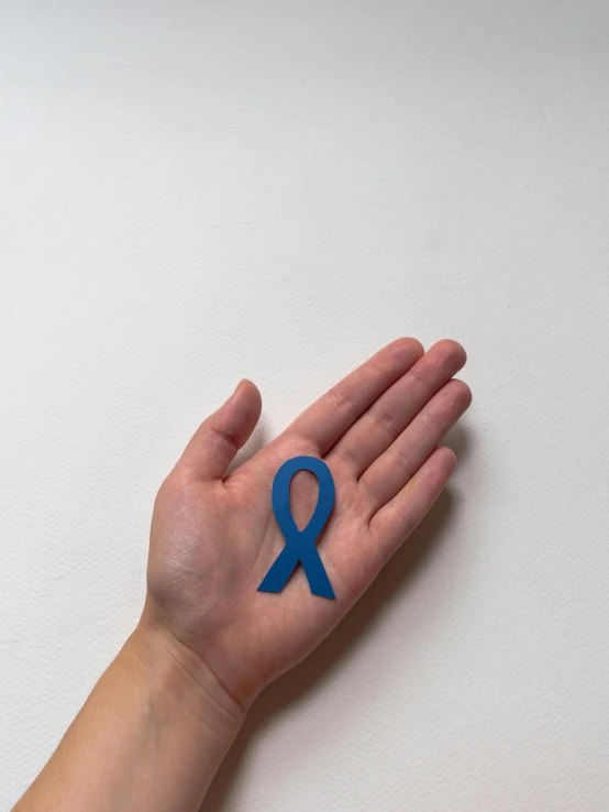 a person holding a blue ribbon in their hand, inspired by Jean Malouel, silicone patch design, instagram post, healthcare, press photo