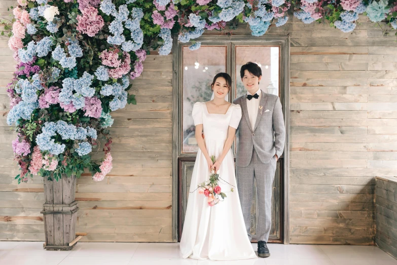 a man and a woman standing in front of a doorway, a picture, by Ayami Kojima, unsplash, bouquet, 15081959 21121991 01012000 4k, tiffany style, d. i. y. venue