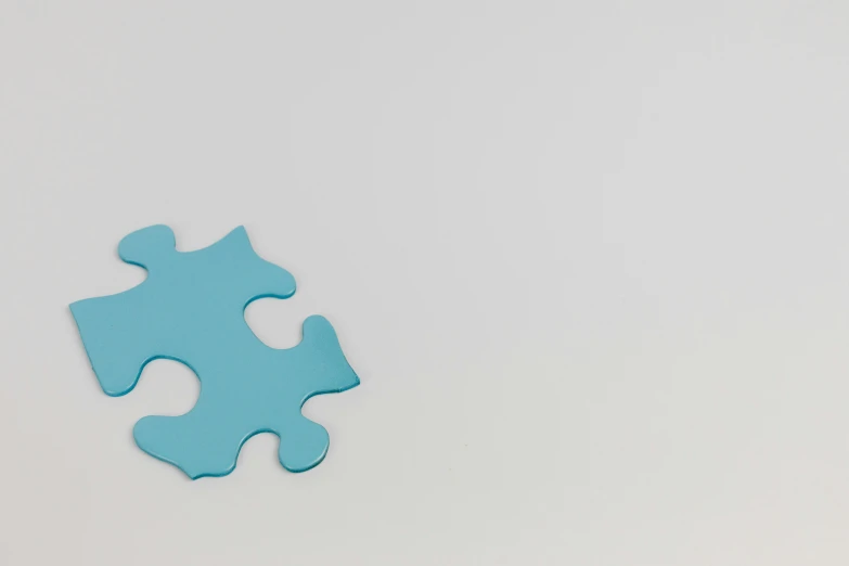 a piece of blue puzzle sitting on top of a table, by Attila Meszlenyi, trending on pexels, conceptual art, white background : 3, motion graphic, background image, miscellaneous objects