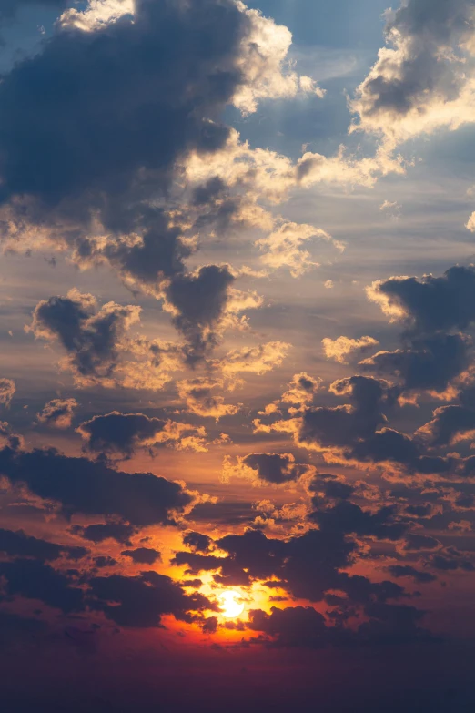 the sun is setting over a body of water, unsplash, romanticism, tall fluffy clouds, major arcana sky, ((sunset)), detailed clouds
