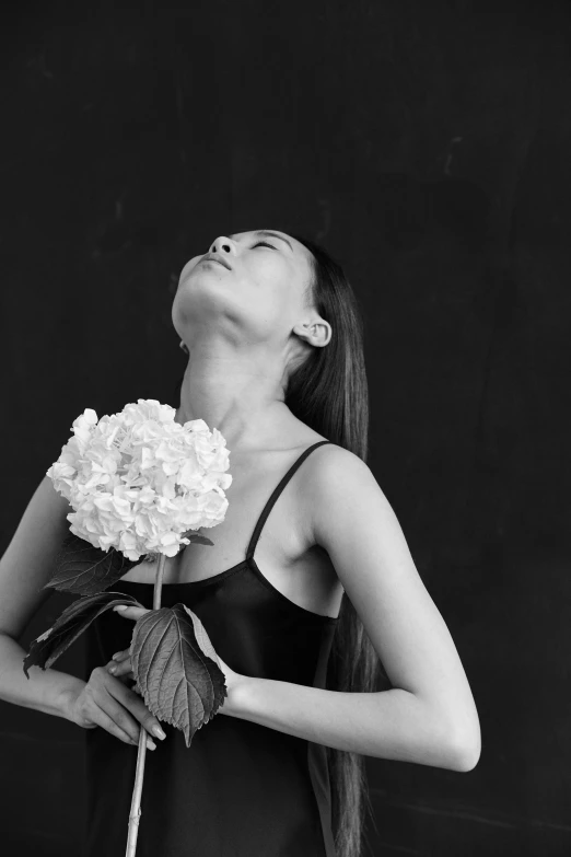a woman in a black dress holding a flower, a black and white photo, inspired by Gao Xiang, unsplash, portrait of ariana grande, body portrait, various posed, 中 元 节