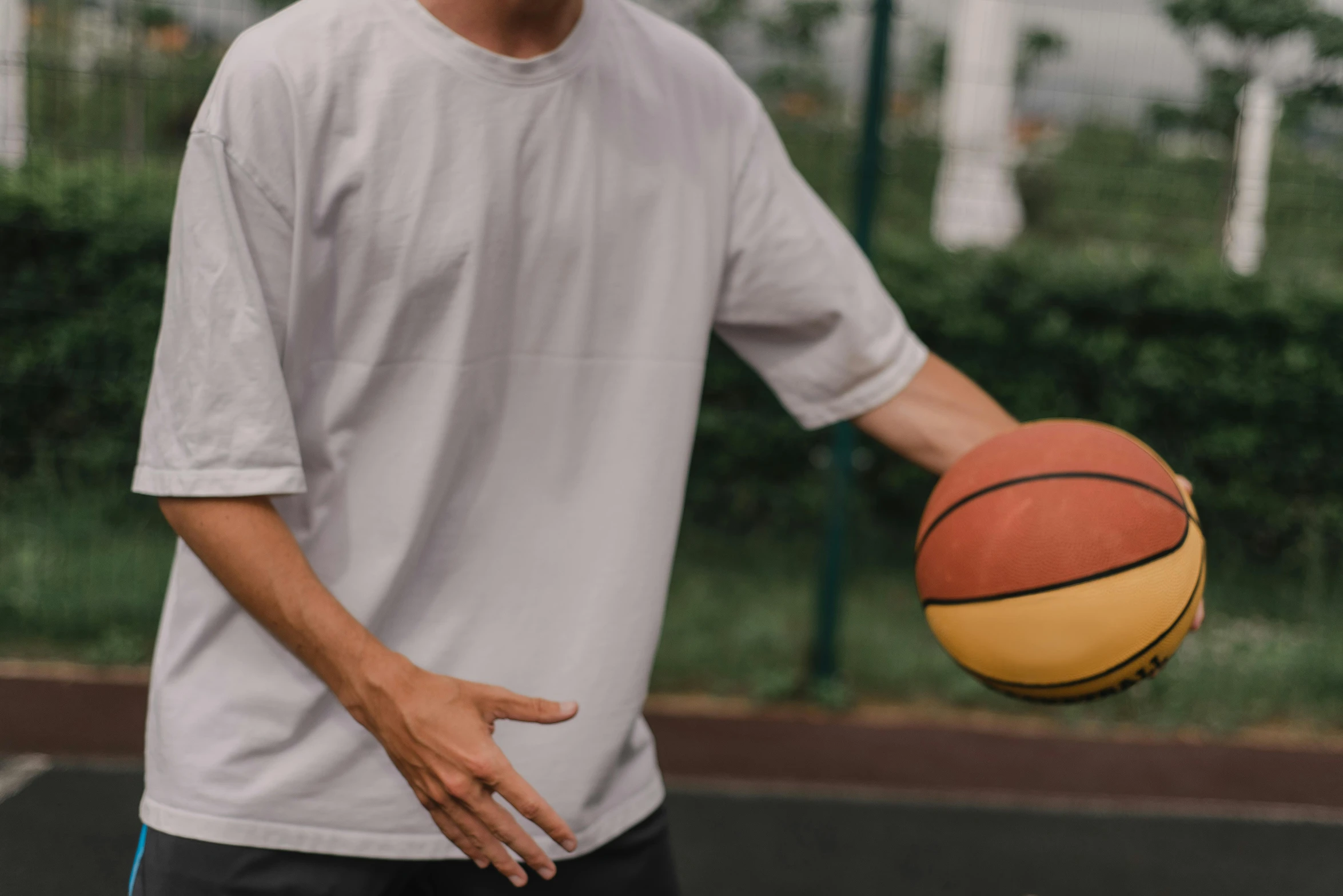 a man standing on a basketball court holding a basketball, trending on dribble, wearing a white button up shirt, bump in form of hand, cysts, wearing a baggy