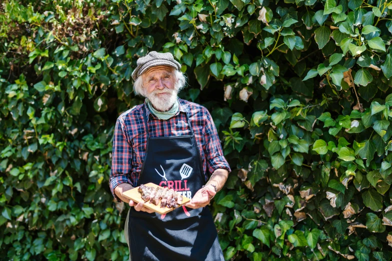 a man that is standing in front of a bush, pulled pork sandwich, old gigachad with grey beard, holding an epée, bulli