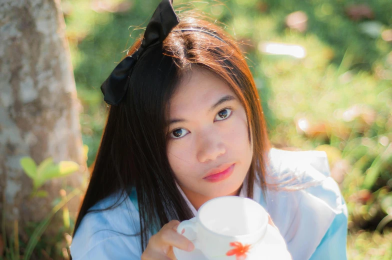 a close up of a person holding a cup, inspired by Ren Renfa, tumblr, dressed as schoolgirl, avatar image, patiphan sottiwilai, profile image