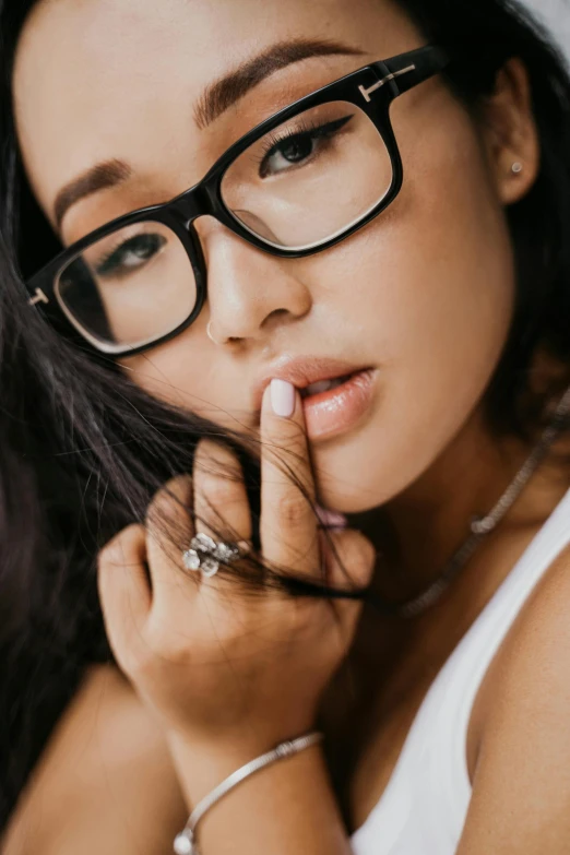 a woman with glasses posing for a picture, an album cover, inspired by Ruth Jên, trending on pexels, natural lips, high angle close up shot, sexy :8, asian descent